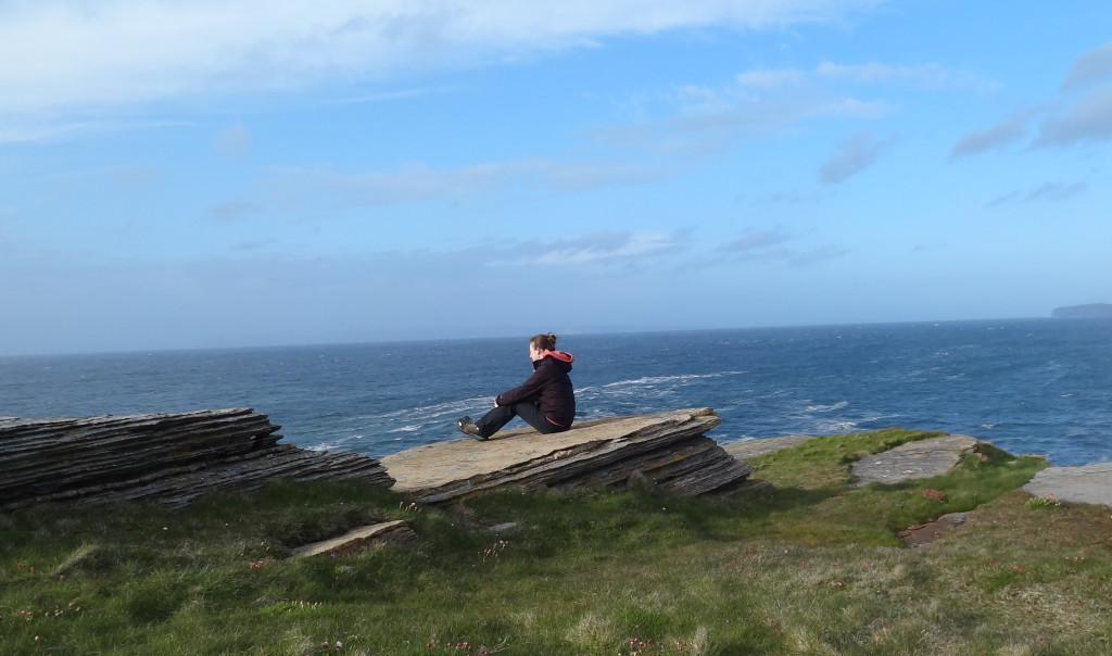 Sitting on a flat rock, looking at the sea